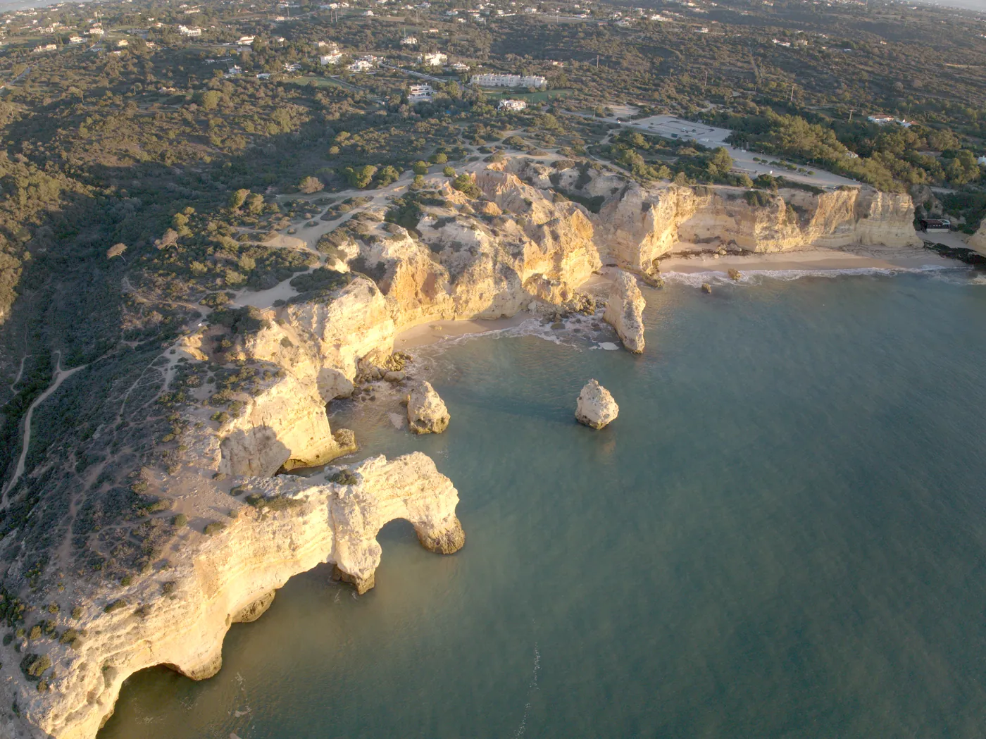 The coast around Praia da Marinha from the air in early morning light